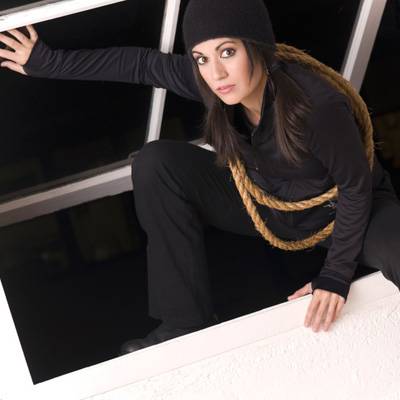 thief climbing in window